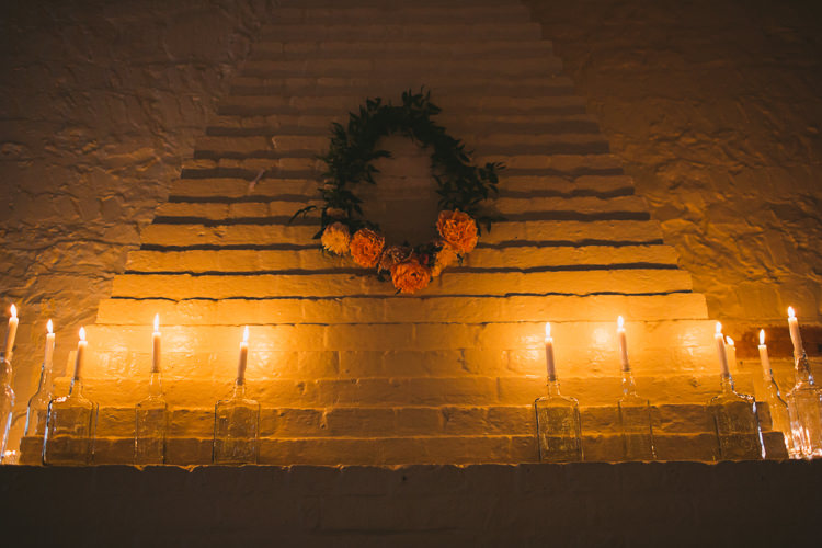 Rose Wreath Candles Fireplace Fairy Lights Vibrant Florals Summer Barn Wedding https://www.oliviajudah.co.uk/