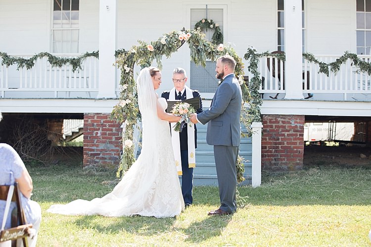Groom Grey Suit Blue Tie Bride Long Veil Lace Dress Sweetheart Neckline Outdoor Ceremony Archway Greenery Intimate Farmhouse Wedding South Carolina https://jessicahuntphotography.com/