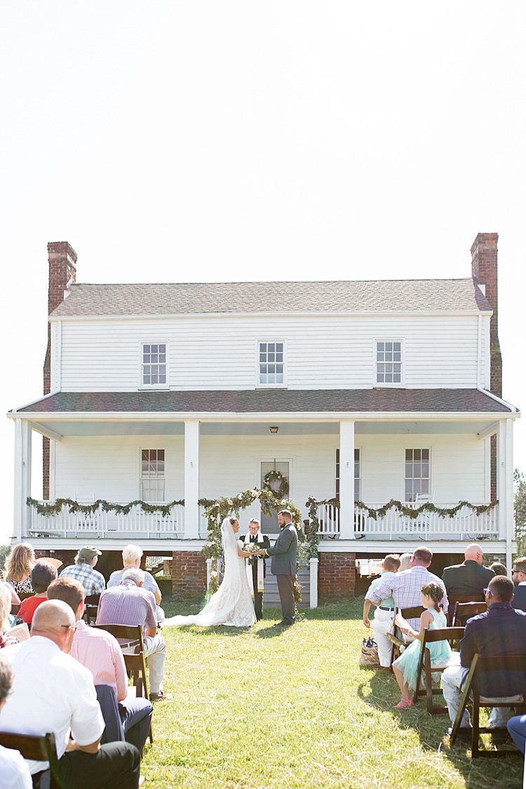 Outdoor Ceremony Guests Greenery Archway Intimate Farmhouse Wedding South Carolina https://jessicahuntphotography.com/