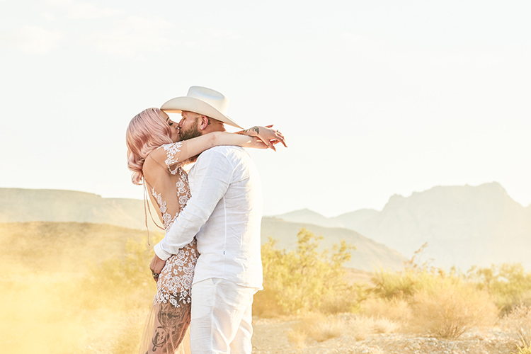 Yellow Smoke Desert Groom Cowboy Hat White Bride Pink Hair Blush Gown Lace Sheer Tattoos Kiss Hip Elvis Las Vegas Destination Wedding http://www.roseimages.co.uk/