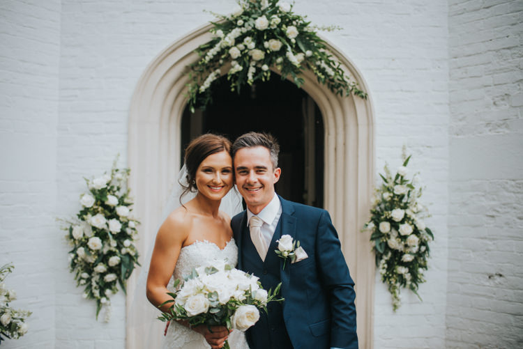 Bride Bridal Pronovias Strapless Sweetheart Fishtail Train Veil White Rose Bouquet Navy Suit Groom Church Display Floral Arrangements Chic Romantic Florals Candlelight Wedding http://lisawebbphotography.co.uk/
