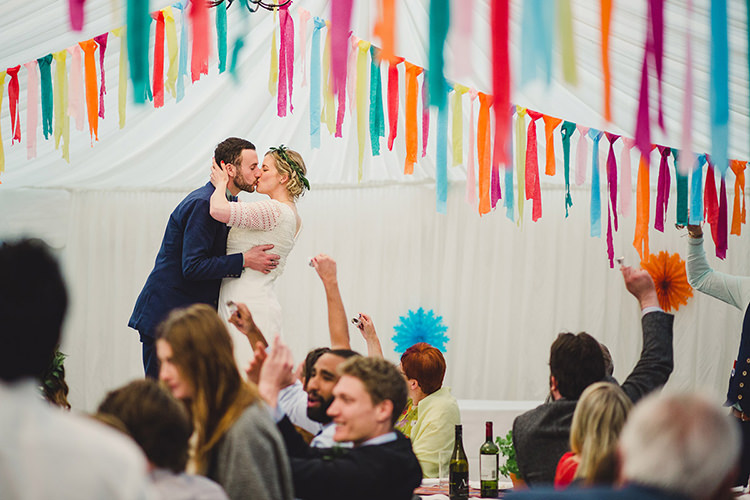 Bride Bridal Lace Guipure Topper Sleeves Dress Gown Veil Greenery Foliage Leaf Crown Bespoke Groom Navy Multicoloured Streamers Marquee Fun Happy Colourful Wedding Vegetable Bouquets https://mylo-photography.co.uk/