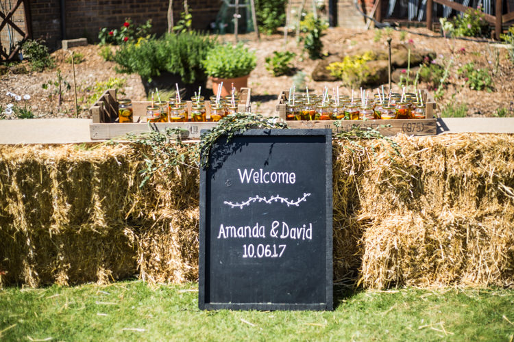 Blackboard Welcome Sign Chalk Board Hay Bales Pimms Natural Outdoor Tipi Wedding https://www.ad-photography.co.uk/