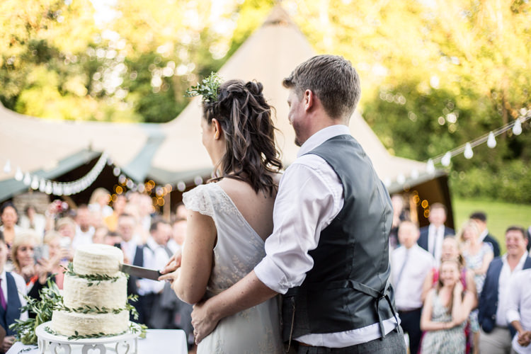 Cake Cutting Buttercream Foliage Greenery Natural Outdoor Tipi Wedding https://www.ad-photography.co.uk/