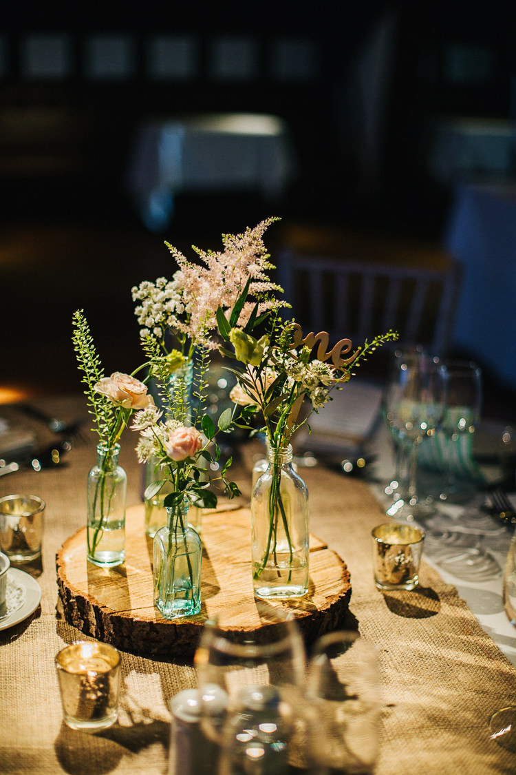 Centrepiece Decor Table Flowers Bottles Jar Log Hessian Exquisite Relaxed Rustic Barn Wedding http://www.emiliemay.com/