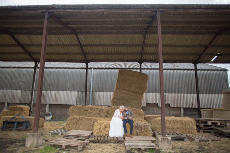 Bride Bridal Dress Gown Charlotte Balbier Long Sleeve V Neck Tweed Three Piece Groom Waistcoat Mismatched Pocket Square Barn Haystack Hay Bales Quirky Rustic Farm Wedding https://ragdollphotography.co.uk/