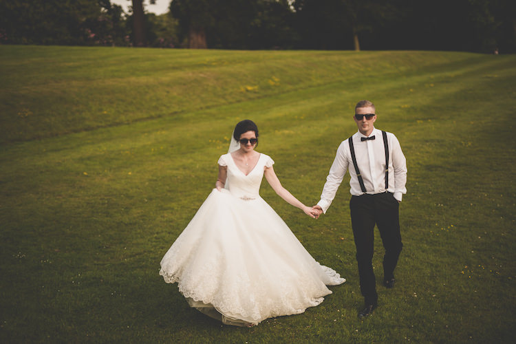 Bride Bridal A Line Ronald Joyce Dress V Neck Cap Sleeve Groom Braces Bow Tie Sunglasses Black Tie Glamour Country Estate Wedding https://www.chrisblackledgephotography.co.uk/