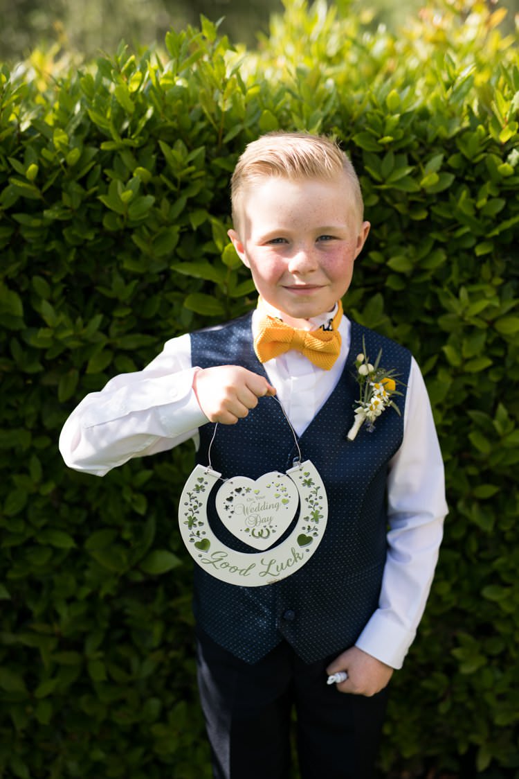 Page Boy Knitted Bow Tie Polka Dot Waistcoat Horseshoe Buttonhole Daisies Yellow Navy Outdoor Tuscany Wedding http://www.natalymontanari.com/