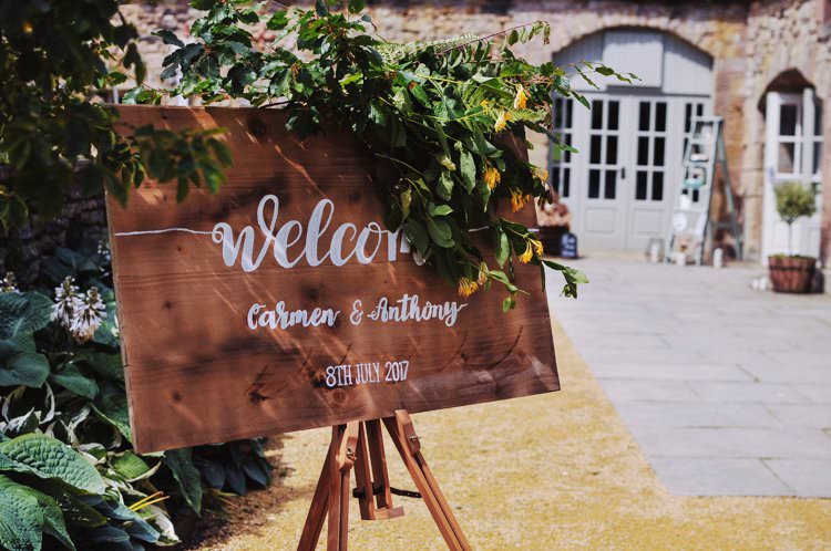 Wooden Welcome Sign Calligraphy Foliage Flowers Bohemian Creative Summer Barn Wedding http://www.pocketsquarephotography.com/