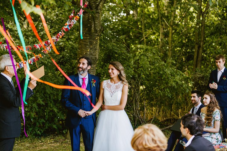 Bride Bridal Lace Embellished Mesh ASOS Sleeveless Tea Length Dress Gown Next Groom Pink Tie Three Piece Waistcoat Outdoor Ceremony Streamers Multicoloured Hand Made Fun Outdoor Wedding https://www.sharrongibson.co.uk/