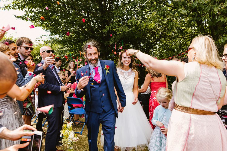 Bride Bridal Lace Embellished Mesh ASOS Sleeveless Tea Length Dress Gown Next Groom Pink Tie Waistcoat Three Piece Confetti Moment Shot Multicoloured Hand Made Fun Outdoor Wedding https://www.sharrongibson.co.uk/