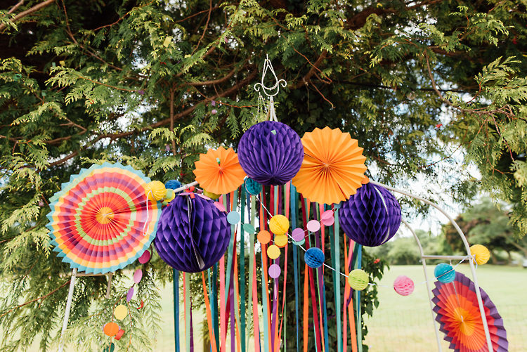 Ceremony Backdrop Ribbons Pinwheels Pom Poms Alternative Colourful Outdoor Humanist Village Hall Wedding http://www.chebirchhayesphotography.com/
