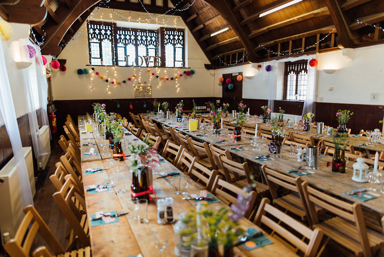 Lighting Pom Poms Long Wooden Tables Alternative Colourful Outdoor Humanist Village Hall Wedding http://www.chebirchhayesphotography.com/