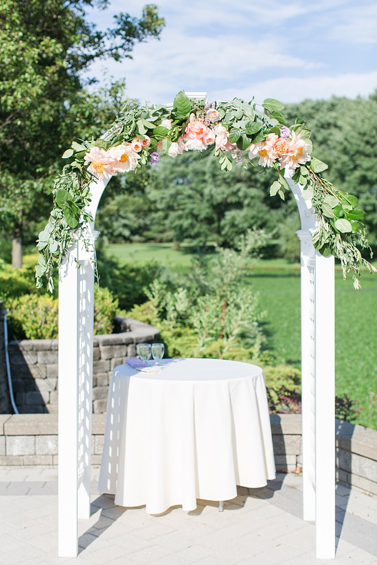 White Archway Roses Greenery Ceremony Outdoors Bright Coral Garden Wedding New Jersey http://somethingbluenj.com/