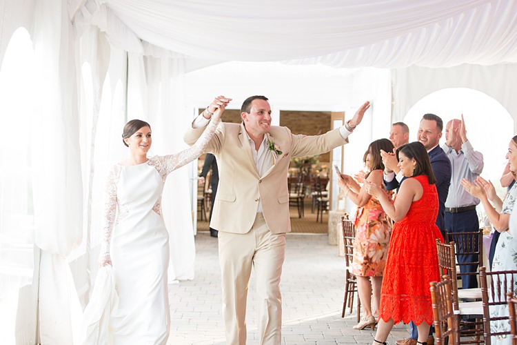 Bride Groom Reception Entrance Lace Gown Sheer Long Sleeves Groom Cream Suit Bright Coral Garden Wedding New Jersey http://somethingbluenj.com/