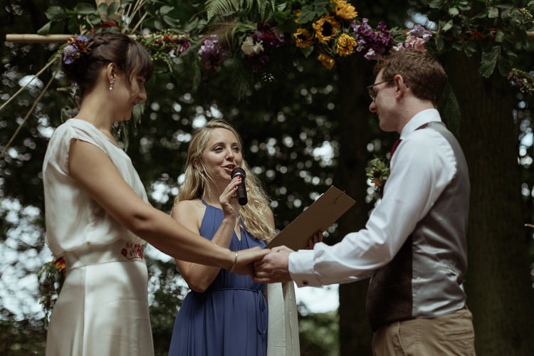 Vows Bamboo Ceremony Structure Floral Flowers Foliage Bespoke Bride Waisted Belt Tweed Groom Waistcoat Chinos Magical Woodland Clearing Colourful Tipis Wedding https://www.lukebellphotography.co.uk/