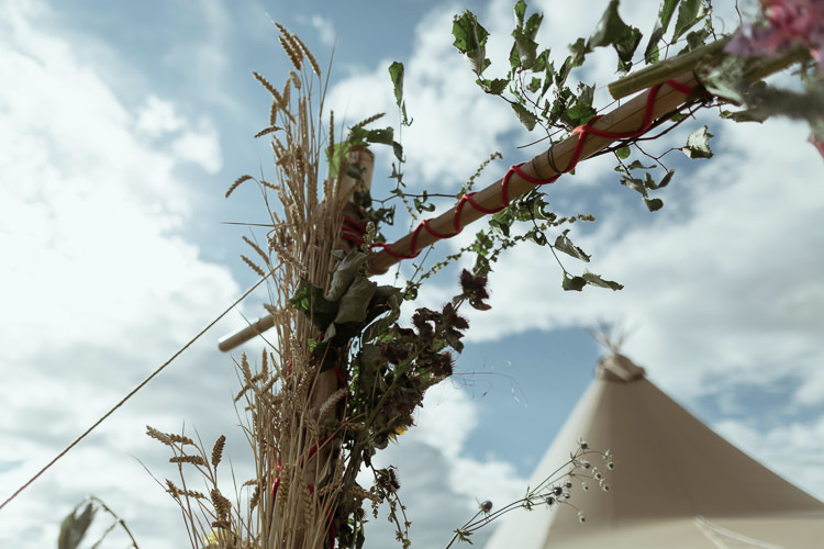 Bamboo Ceremony Structure Wheat Foliage Floral Flowers Magical Woodland Clearing Colourful Tipis Wedding https://www.lukebellphotography.co.uk/