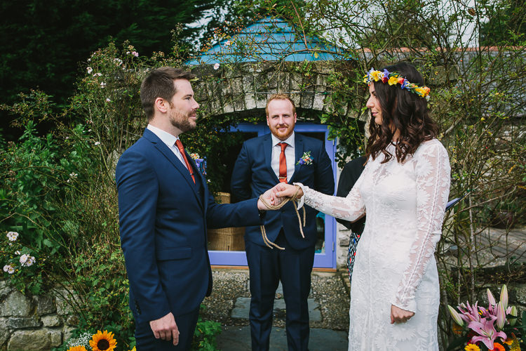 Bride Bridal Rue de Seine Dress Gown Lace Sweetheart Overlay Flower Crown Multicolour Wildflower Bouquet Sunflower Navy Three Piece Waistcoat Groom Orange Tie Fisherman's Love Knot Handfasting Small Colourful Cool Alternative Wedding https://www.alexapoppeweddingphotography.com/