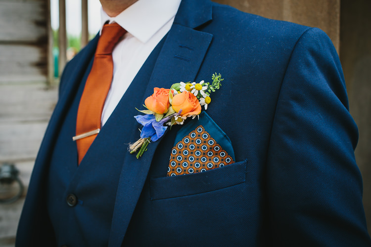 Navy Three Piece Suit Waistcoat Groom Silk Pocket Square Buttonhole Wildflower Daisy Orange Tie Small Colourful Cool Alternative Wedding https://www.alexapoppeweddingphotography.com/