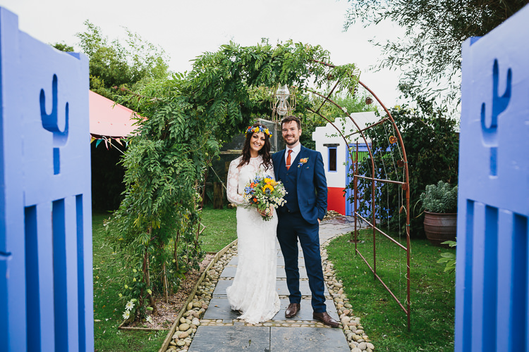 Bride Bridal Rue de Seine Dress Gown Lace Sweetheart Overlay Flower Crown Multicolour Wildflower Bouquet Sunflower Navy Three Piece Waistcoat Groom Orange Tie Small Colourful Cool Alternative Wedding https://www.alexapoppeweddingphotography.com/