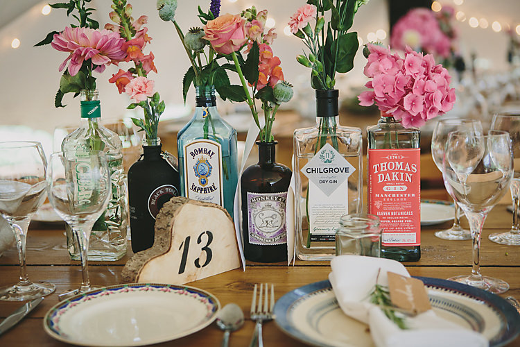 Table Centre Number Wood Slice Stencil Bottles Blooms Floral Flowers Setting Pretty Country Gin Wedding http://www.victoriasomersethowphotography.co.uk/