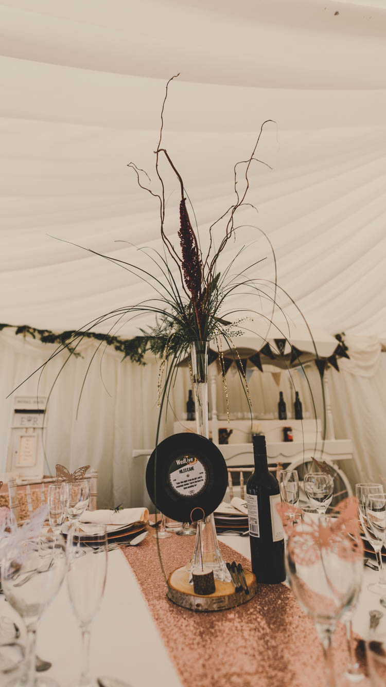 Tall Table Centre Flute Vase Floral Flowers Foliage Record Wood Slice Rose Gold Sequins Greenery Musical Wedding https://www.jademaguirephotography.uk/