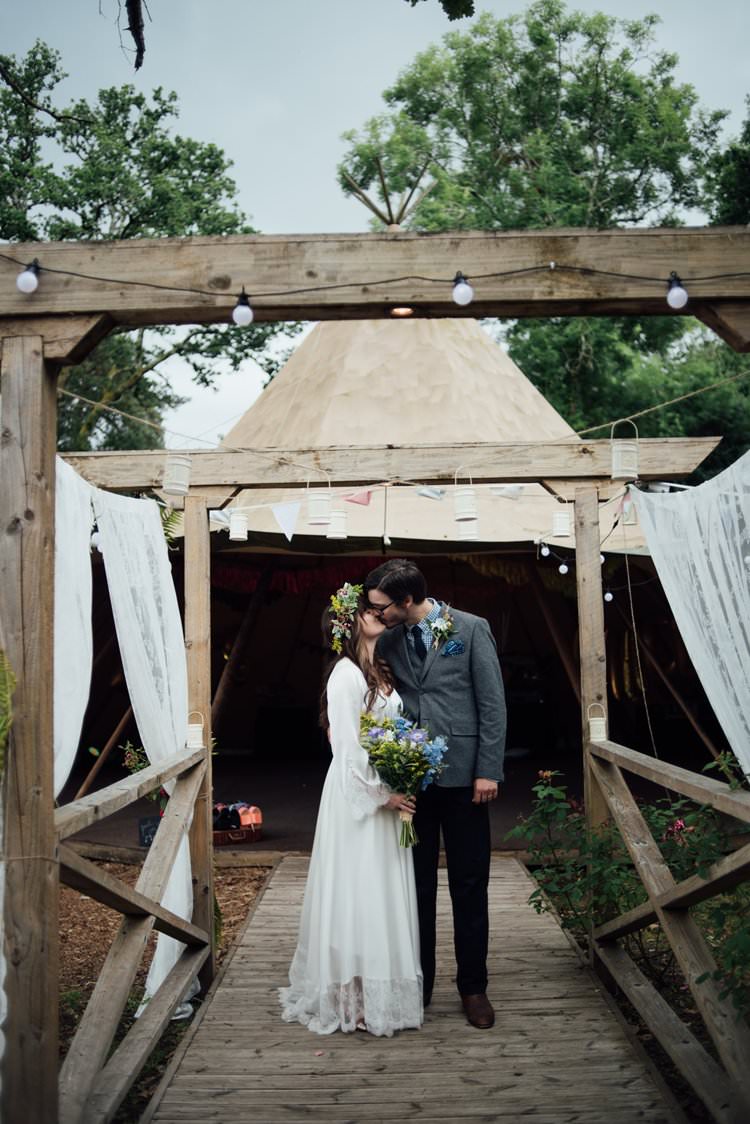 Bride Bridal Flower Crown Wildflower Bouquet Meadow long Sleeve Silk Dress 70s Grey Tweed Suit Navy Trousers Gingham Shirt Blue Festoon Lighting Adventurous Festival Bohemian Wedding https://libertypearlphotography.com/