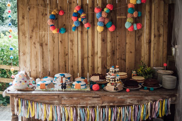Cake Table Pom Pom Sign Tassels Multicolour Rustic Wooden Adventurous Festival Bohemian Wedding https://libertypearlphotography.com/