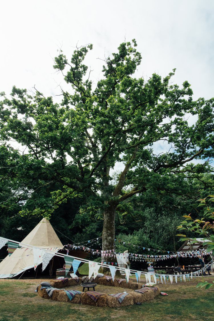 Straw Hay Bales Bunting Adventurous Fire Pit Tipi Blankets Plaid Tartan Festival Bohemian Wedding https://libertypearlphotography.com/