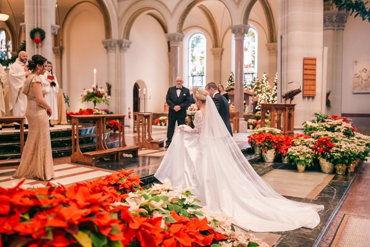Christmas Decor Red Poinsettia Veil Train Cathedral Church Ceremony | Festive Glamour Christmas New Years Eve Wedding http://www.stevendrayimages.com/