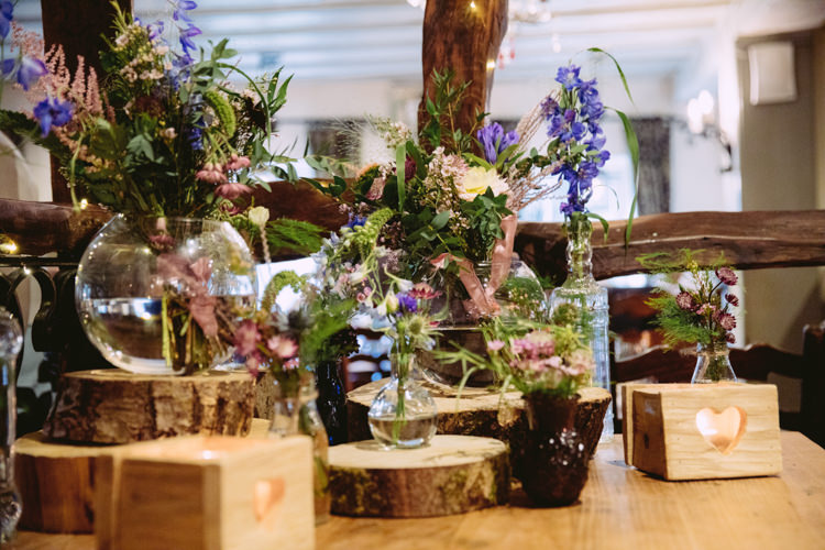 Mismatched Jar Fish Bowl Flowers Floral Wood Slice Log Rustic Cosy Autumn Wedding Lake District http://hayleybaxterphotography.com/