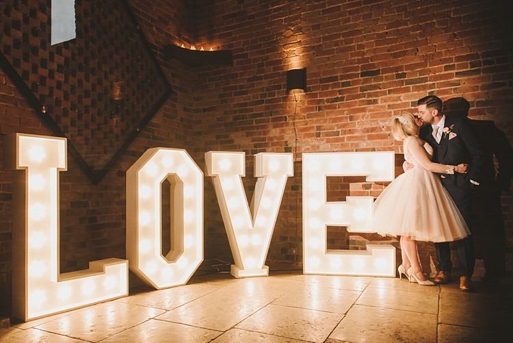 LOVE Letter Lights Untraditional Pretty Travel Barn Wedding https://www.georgimabee.com/