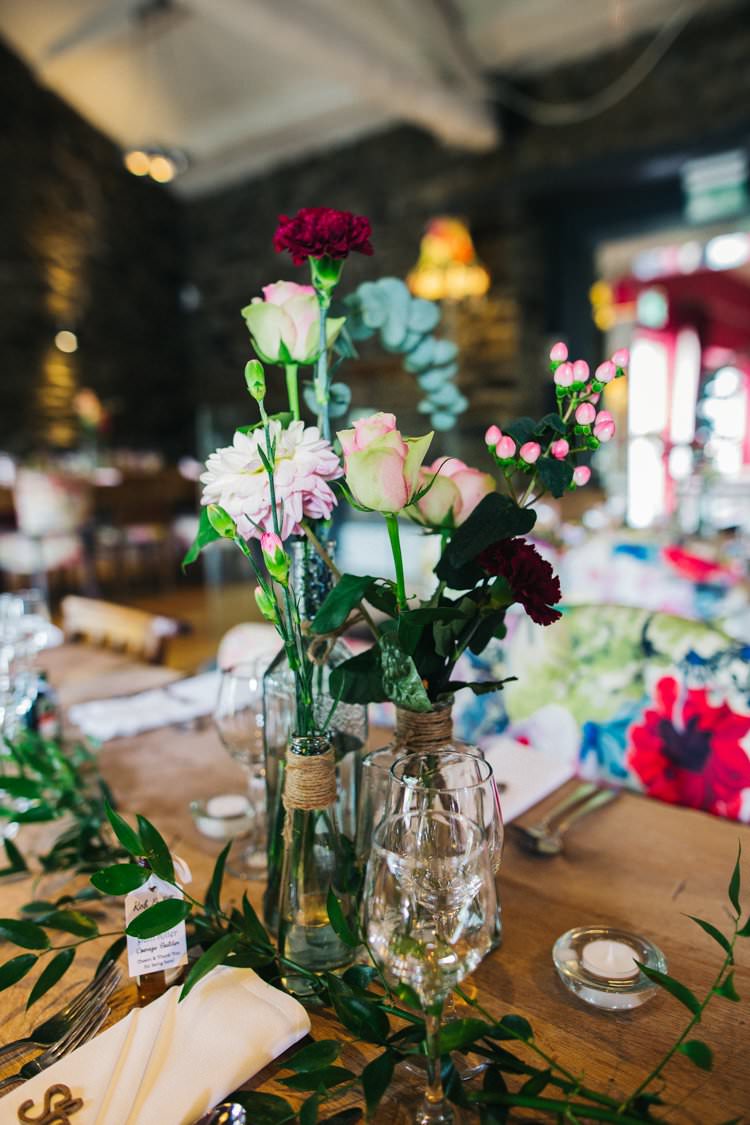Mismatched Jars Bottles Roses Foliage Flowers Twine Colourful Floral Family Friendly Wedding http://www.sallytphoto.com/