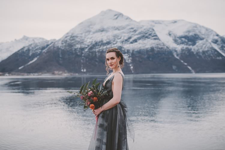 Bride Grey Black Couture Dress Updo Bouquet Norway Mountain Elopement | Moody Chic Norwegian Fjord Wedding Ideas https://www.anoukfotografeert.nl/