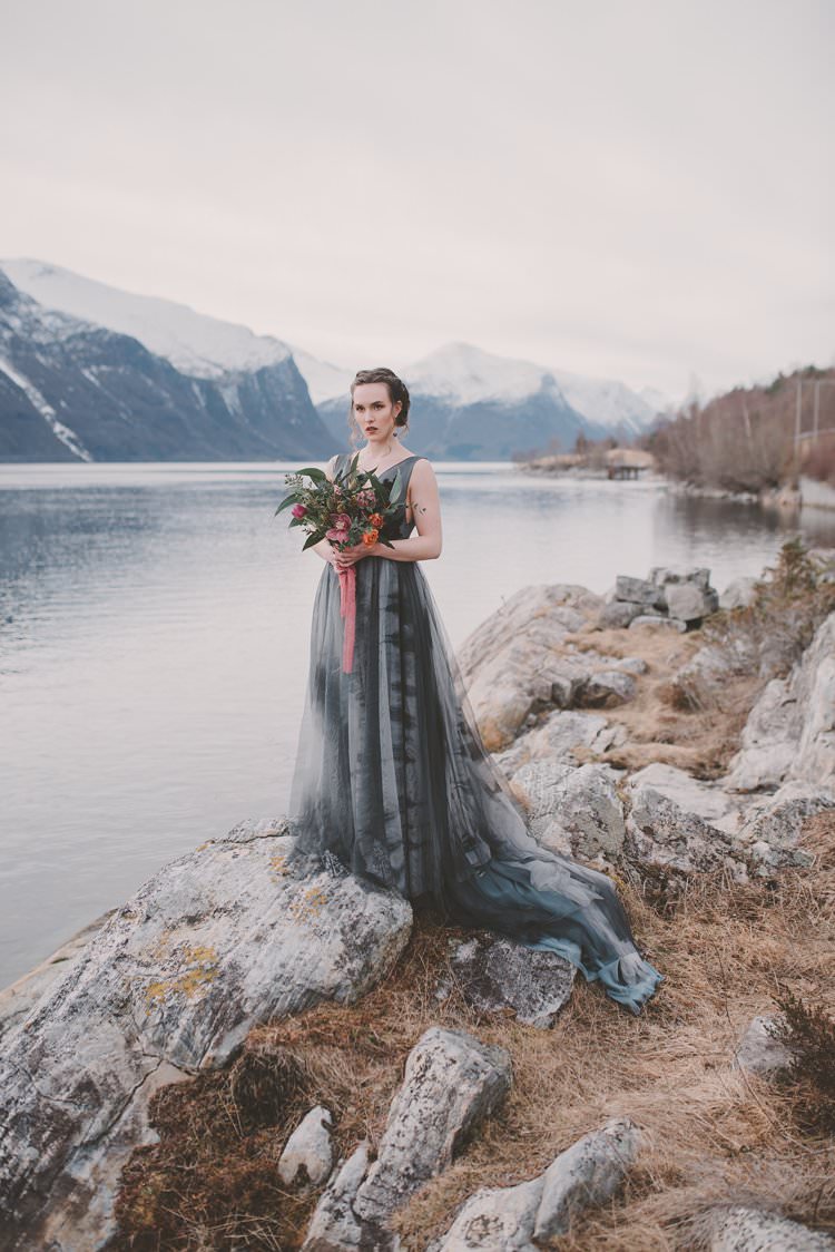 Bride Grey Black Couture Dress Pink Bouquet Updo Norway Mountain Elopement | Moody Chic Norwegian Fjord Wedding Ideas https://www.anoukfotografeert.nl/