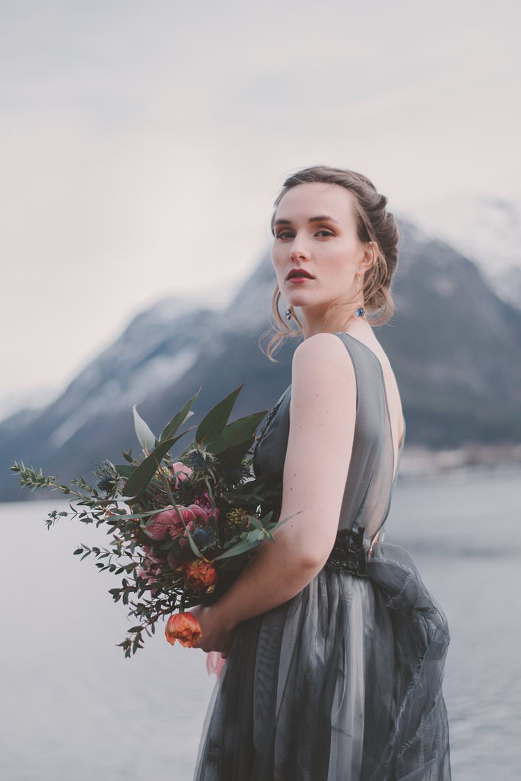 Bride Grey Black Couture Dress Updo Bouquet Norway Mountain Elopement | Moody Chic Norwegian Fjord Wedding Ideas https://www.anoukfotografeert.nl/