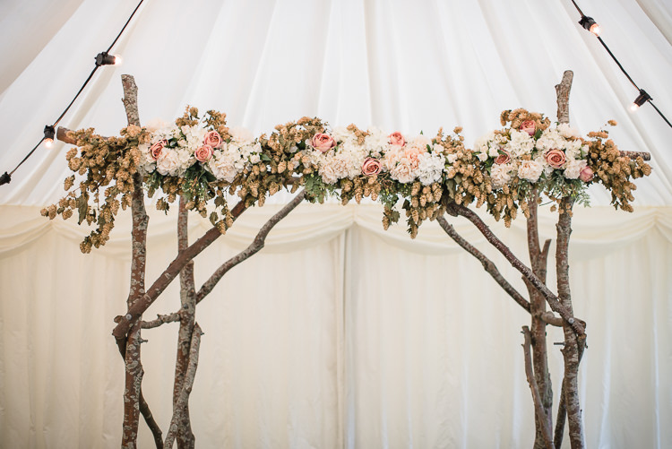 Ceremony Backdrop Tree Wood Hops Pastel Flowers Floral Arbour Personal Homegrown Country Farm Wedding https://www.emmahare.com/