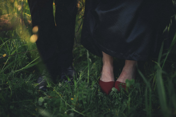 Dark Moody Black Dress Bride Groom Red Shoes Grass Outdoor | Edgy Emerald City Wedding Ideas http://www.yvonnegollphotography.com/