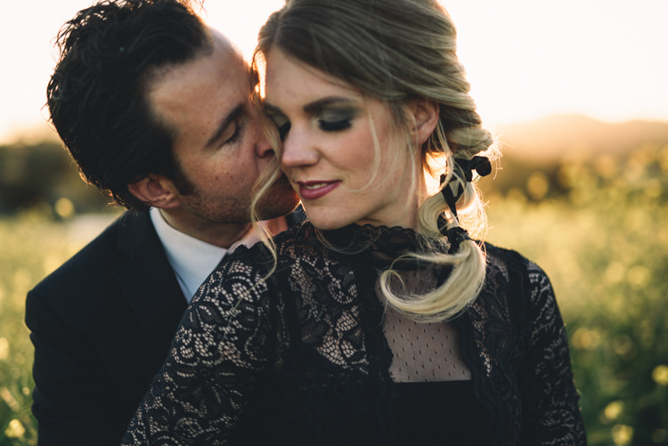 Dark Moody Black Green Gold Bride Groom Outdoor Kiss Embrace Field | Edgy Emerald City Wedding Ideas http://www.yvonnegollphotography.com/