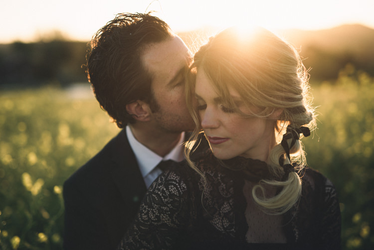 Dark Moody Black Dress Green Field Outdoor Kiss Groom Bride Braid | Edgy Emerald City Wedding Ideas http://www.yvonnegollphotography.com/