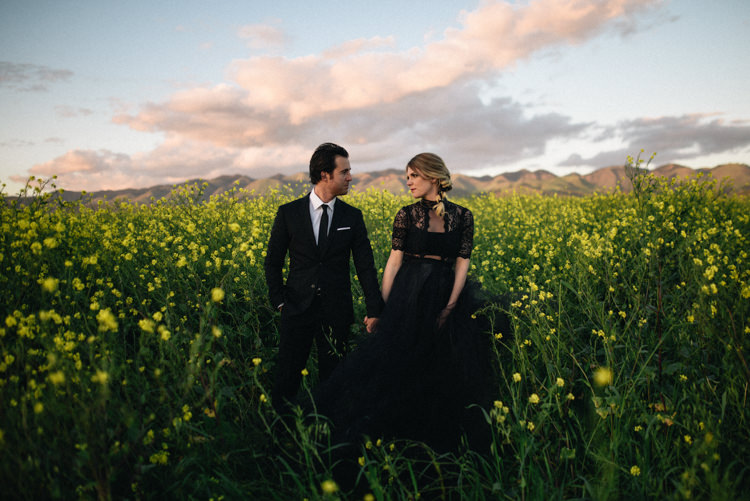 Dark Moody Black Dress Bride Lace Sleeves Outdoor Field Flowers | Edgy Emerald City Wedding Ideas http://www.yvonnegollphotography.com/