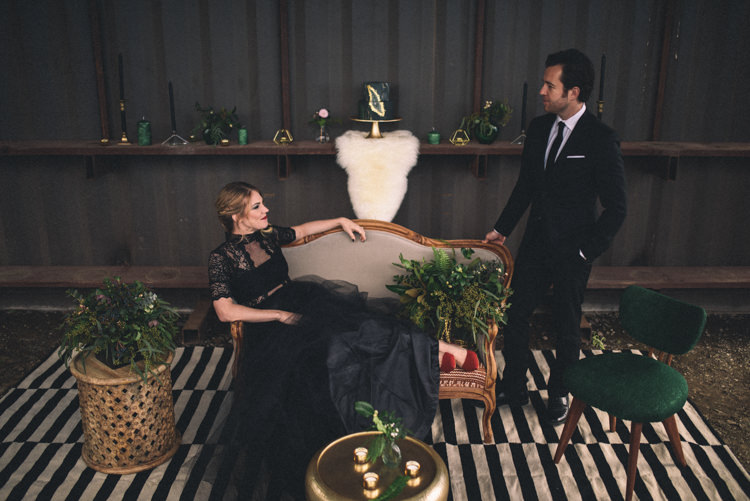 Dark Moody Black Dress Bride Groom Lounge Gold Green Decor Red Shoes | Edgy Emerald City Wedding Ideas http://www.yvonnegollphotography.com/