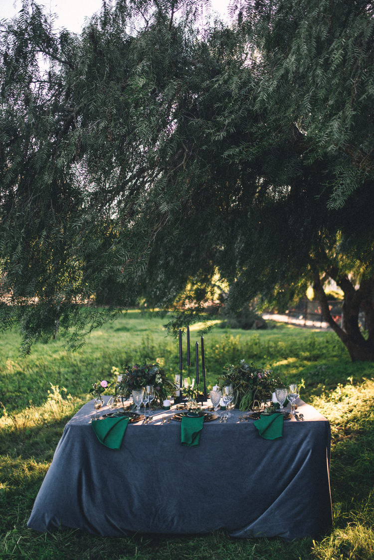 Dark Moody Black Green Gold Table Decor Candle Linen Trees Outdoor | Edgy Emerald City Wedding Ideas http://www.yvonnegollphotography.com/
