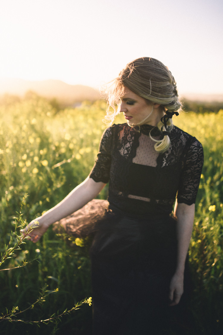 Dark Moody Black Dress Bride Field Outdoor Braid Lace Sleeves | Edgy Emerald City Wedding Ideas http://www.yvonnegollphotography.com/