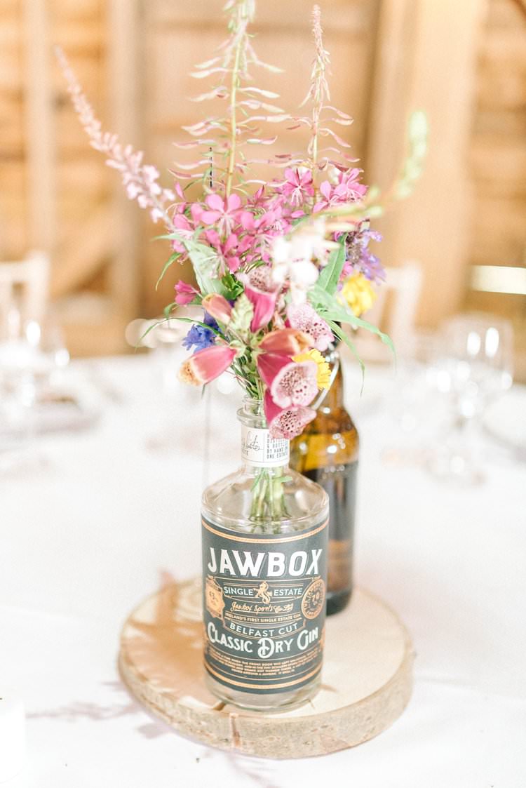 Gin Bottle Flowers Centrepiece Table Log Slice Rustic Summer Country DIY Barn Wedding http://sarahjaneethan.co.uk/