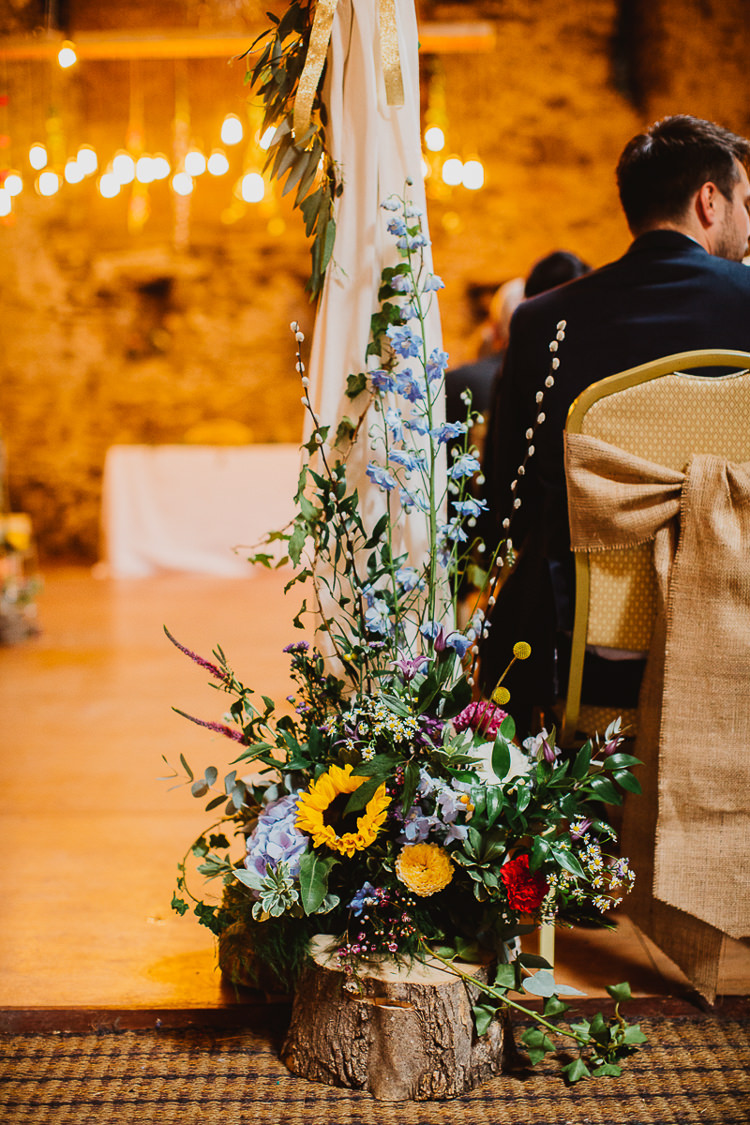 Flowers Log Slice Ceremony Summer Colourful DIY Floral Luxe Barn Wedding http://www.joemather-photography.co.uk/