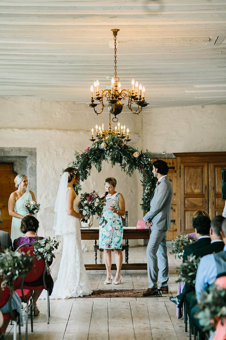 Destination Ceremony Bride Groom Aisle Wild Natural Bouquet Chandeliers Floral Arch Celebrant | Romantic Castle Switzerland Wedding http://kbalzerphotography.com/