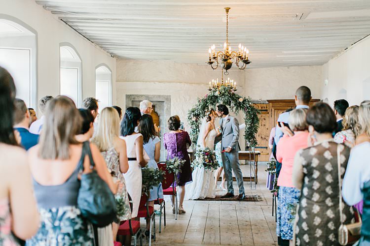 Destination Ceremony Bride Groom Aisle Wild Natural Bouquet Chandeliers Floral Arch | Romantic Castle Switzerland Wedding http://kbalzerphotography.com/
