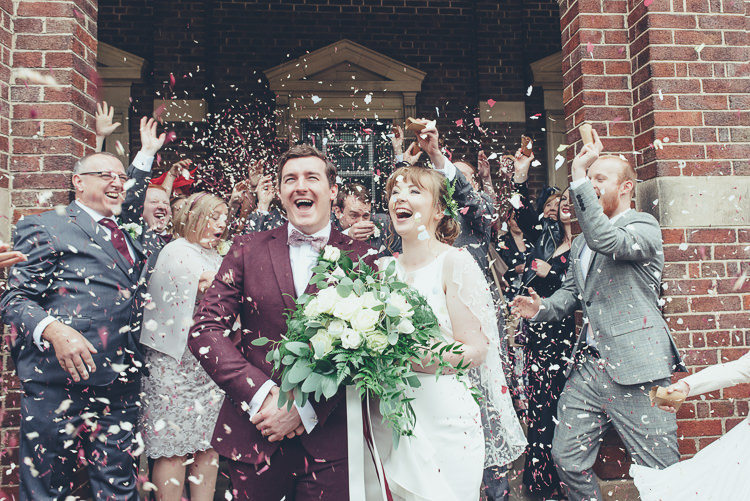 Bride Groom Confetti Shot After Ceremony Church Happy Family Burgundy Suit Wild Foliage Bouquet | Greenery Burgundy City Autumn Wedding http://lisahowardphotography.co.uk/