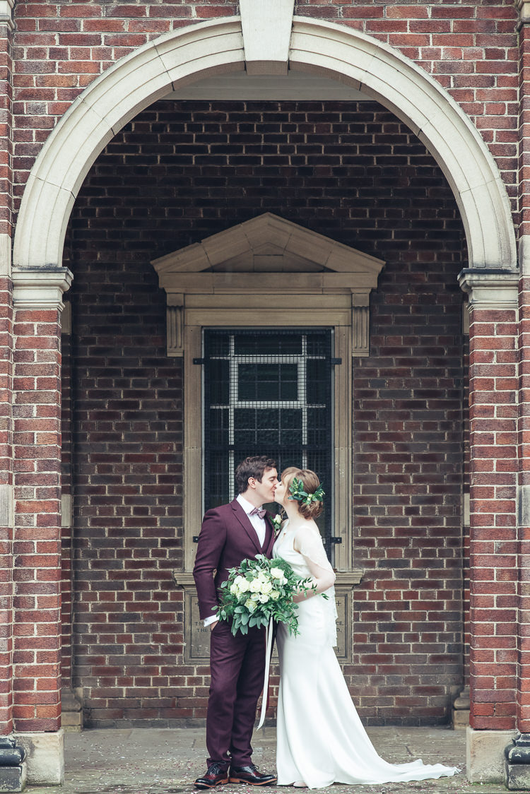 Bride Groom Kiss After Ceremony Romantic Industrial Brick Building Wild Foliage Bouquet | Greenery Burgundy City Autumn Wedding http://lisahowardphotography.co.uk/